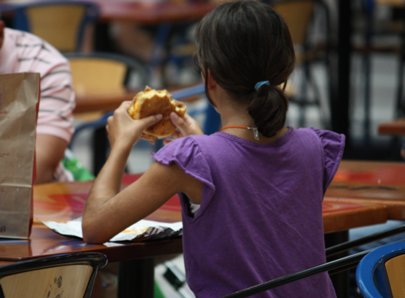 young girl eats in food court, sandwich, Graphics project