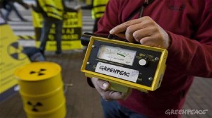 An activist  holds a geiger counter during an action where two Greenpeace radiation specialists and dozens of trained volunteers deliver samples of radioactive waste in two concrete and lead-lined containers collected from unsecured public  locations (Sellafield beach in the UK; the seabed at la Hague in France; the banks of the Molse Nete River in Belgium; and from the uranium mining village of Akokan in Niger) to the door of European Union Parliament. The Greenpeace activity is to remind MEPs, in their last plenary session, before considering a new nuclear waste law that there is no 
solution to nuclear waste.