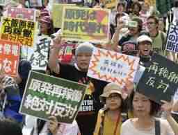 関西電力大飯原発３、４号機の再稼働に抗議し、プラカードを掲げデモ行進する人たち＝１７日午後、福井市